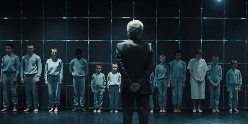 Brenner stands among the Hawkins Lab test subjects in Stranger Things 4