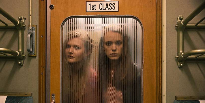 Two women behind a door on a train that says first class in Nymphomaniac
