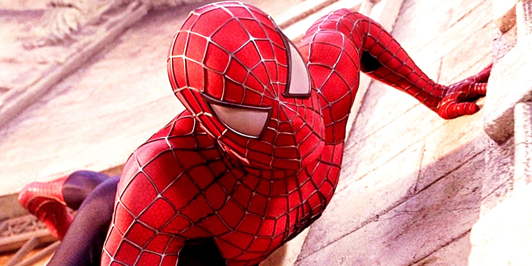 Tobey Maguire as Spider-Man crawling up a wall in Spider-Man 2