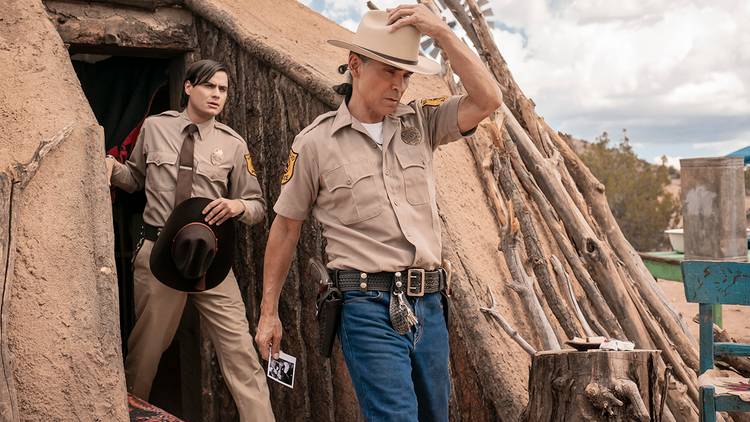 Zahn McClarnon and Kiowa Gordon walking in the open in Dark Winds