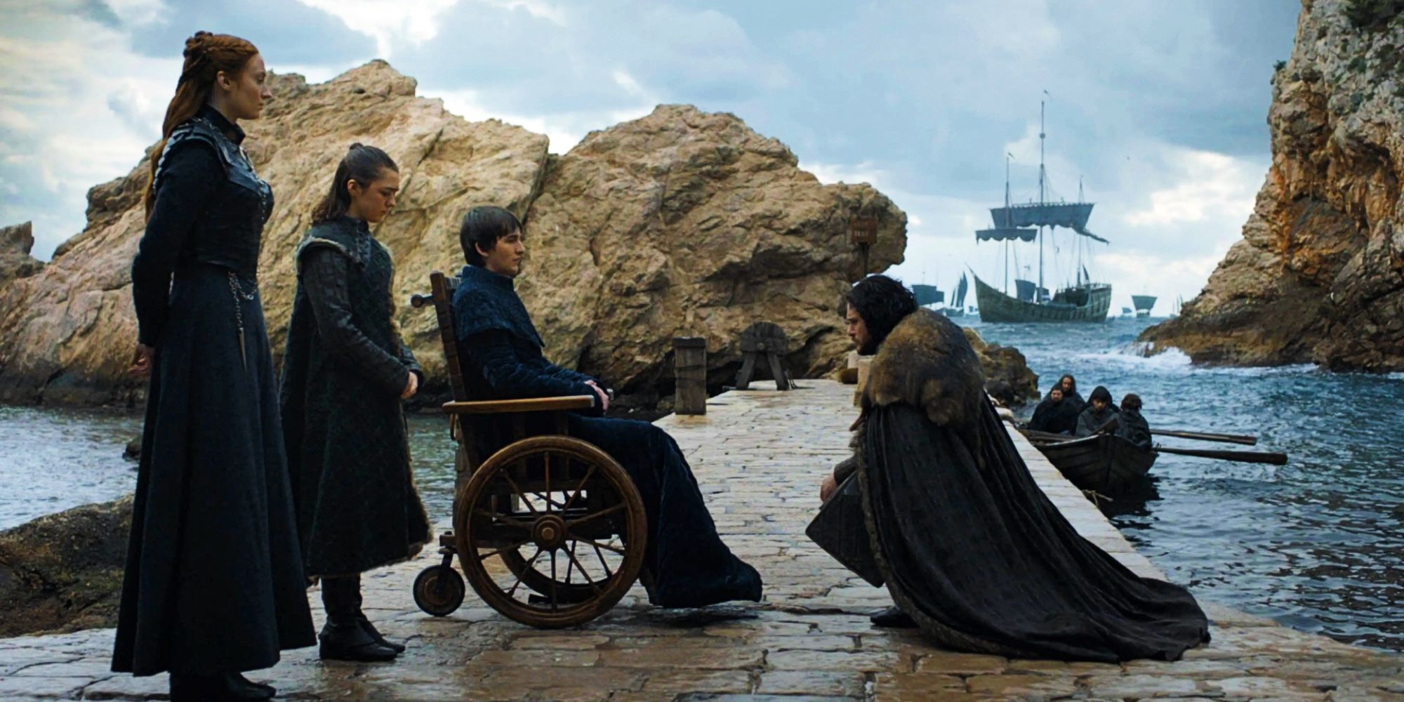 Jon Snow kneeling before Bran, next to Sansa and Arya, in Game of Thrones' series finale