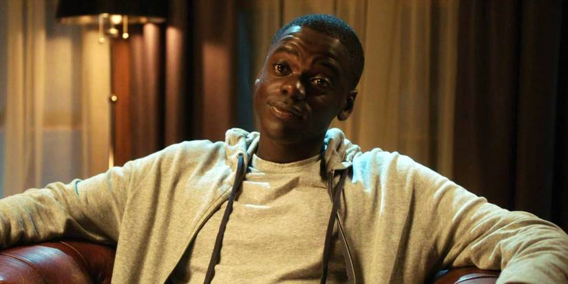Daniel Kaluuya sitting in a chair with his head tilted to the side in Get Out