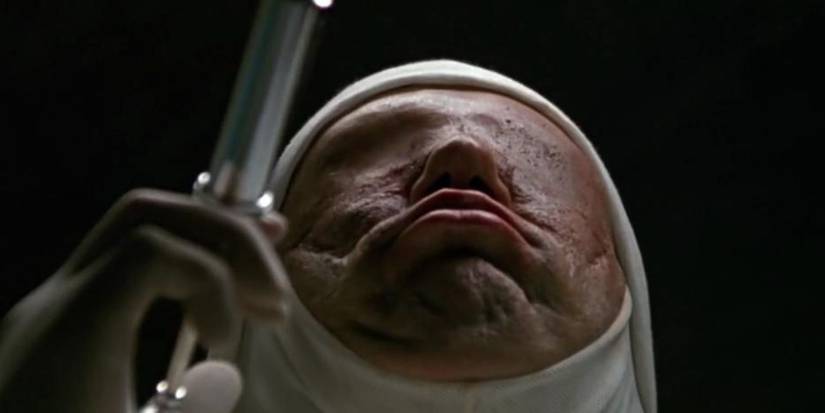 Eyeless doctor holding a syringe in Jacob's Ladder. 