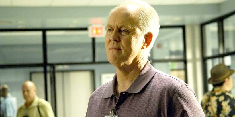 John Lithgow as Trinity Killer smiling in an office in Dexter