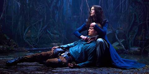 Rand lies unconscious in Moiraine's arms while she holds a knife to his throat in Wheel of Time season 1