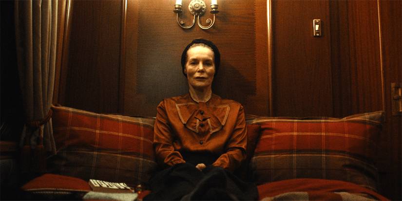 alice krige aitting on a sofa in she will