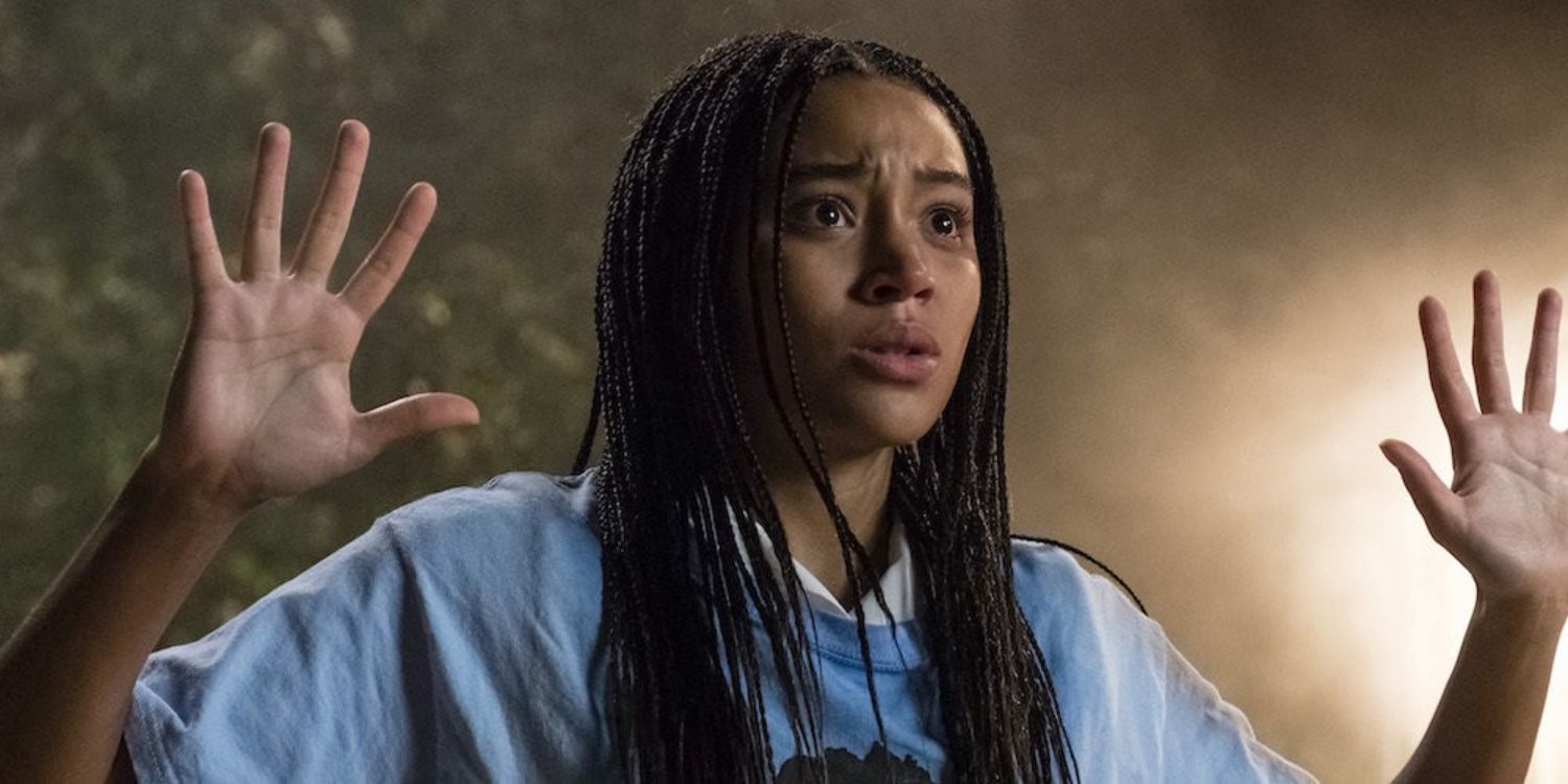 An image of Starr holding her hands up in The Hate U Give