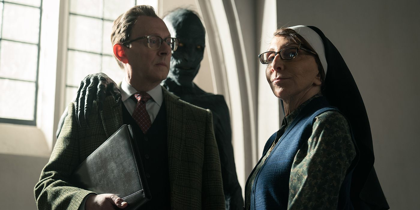 Andrea Martin and Michael Emerson with a creature behind them in Evil Season 3