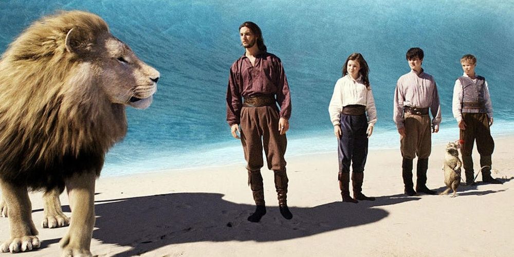 Aslan standing with the heroes next to a waterfall in Narnia 3