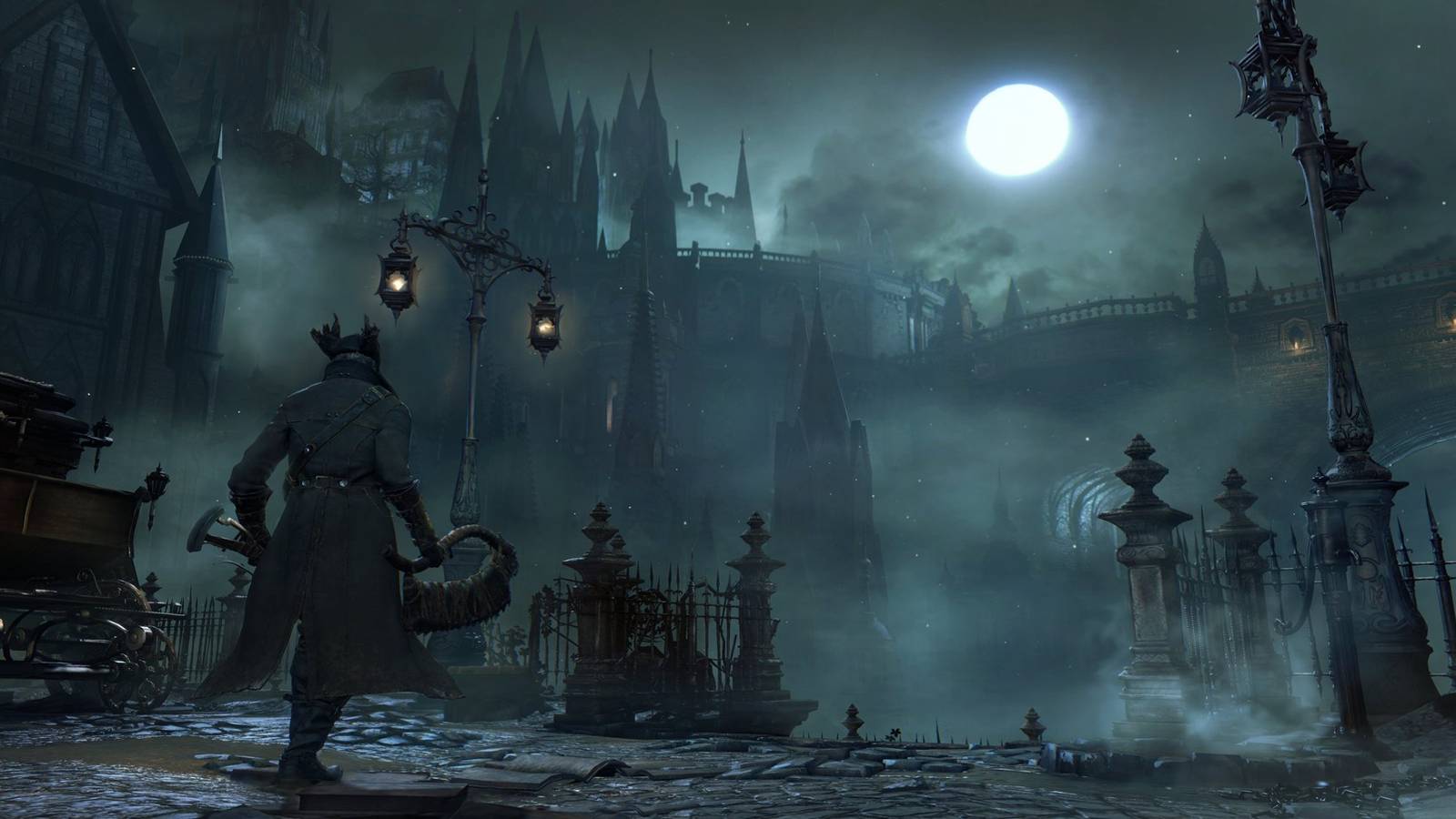 The city of Yarnham lit by lampposts at night in Bloodborne.