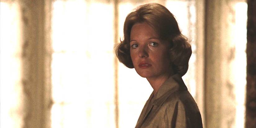 Diane Keaton as Kay in The Godfather looking alarmed in front of white curtains