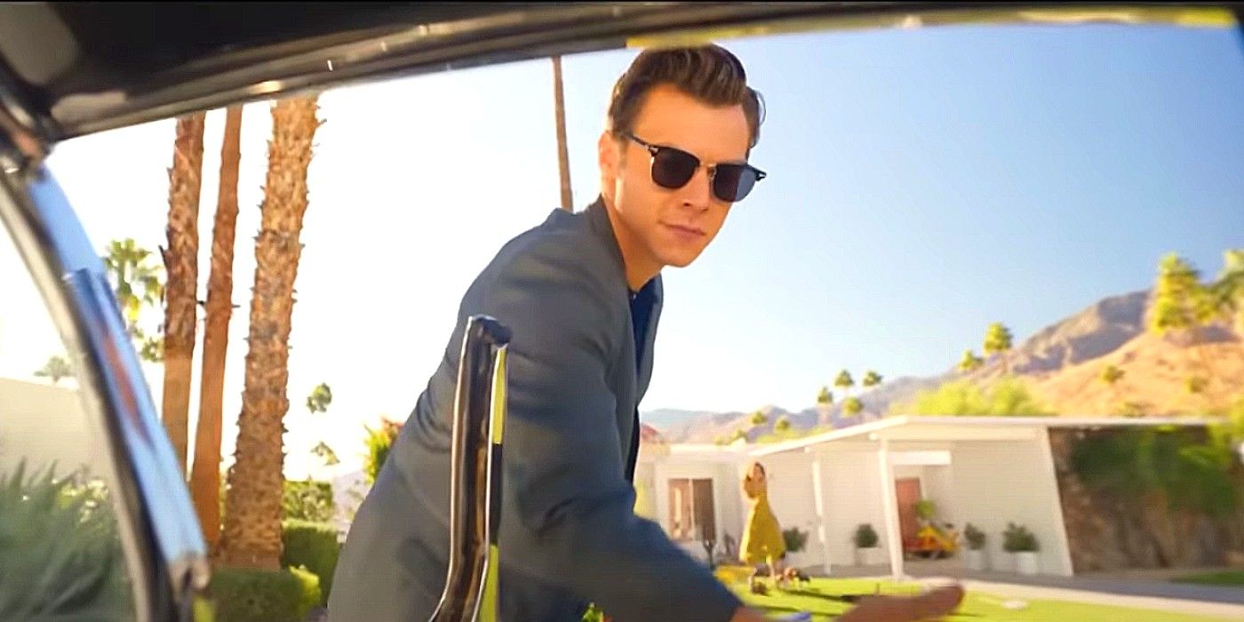 Harry Styles' Jack opens a car door in Don't Worry Darling