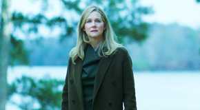 Laura Linney as Wendy standing in front of a lake in Ozark