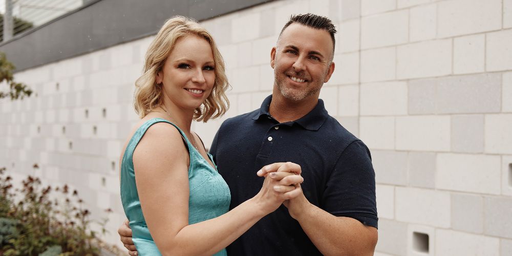 Lindsey and Mark hold hands outdoors on Married At First Sight