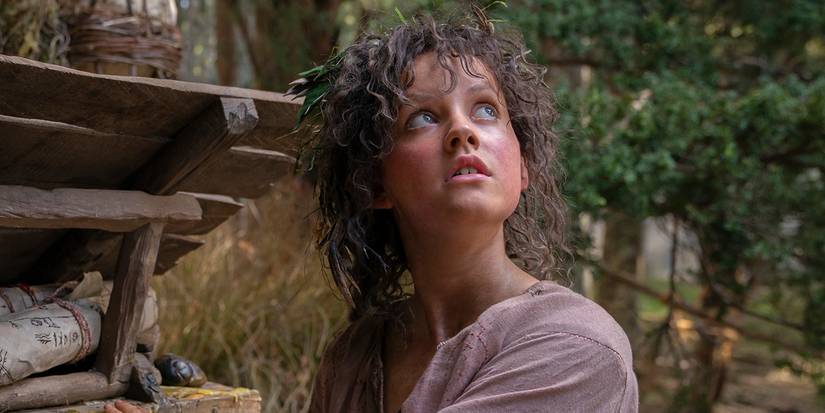 Markella Kavenagh as Nori Brandyfoot looking up in The Lord of the Rings: The Rings of Power