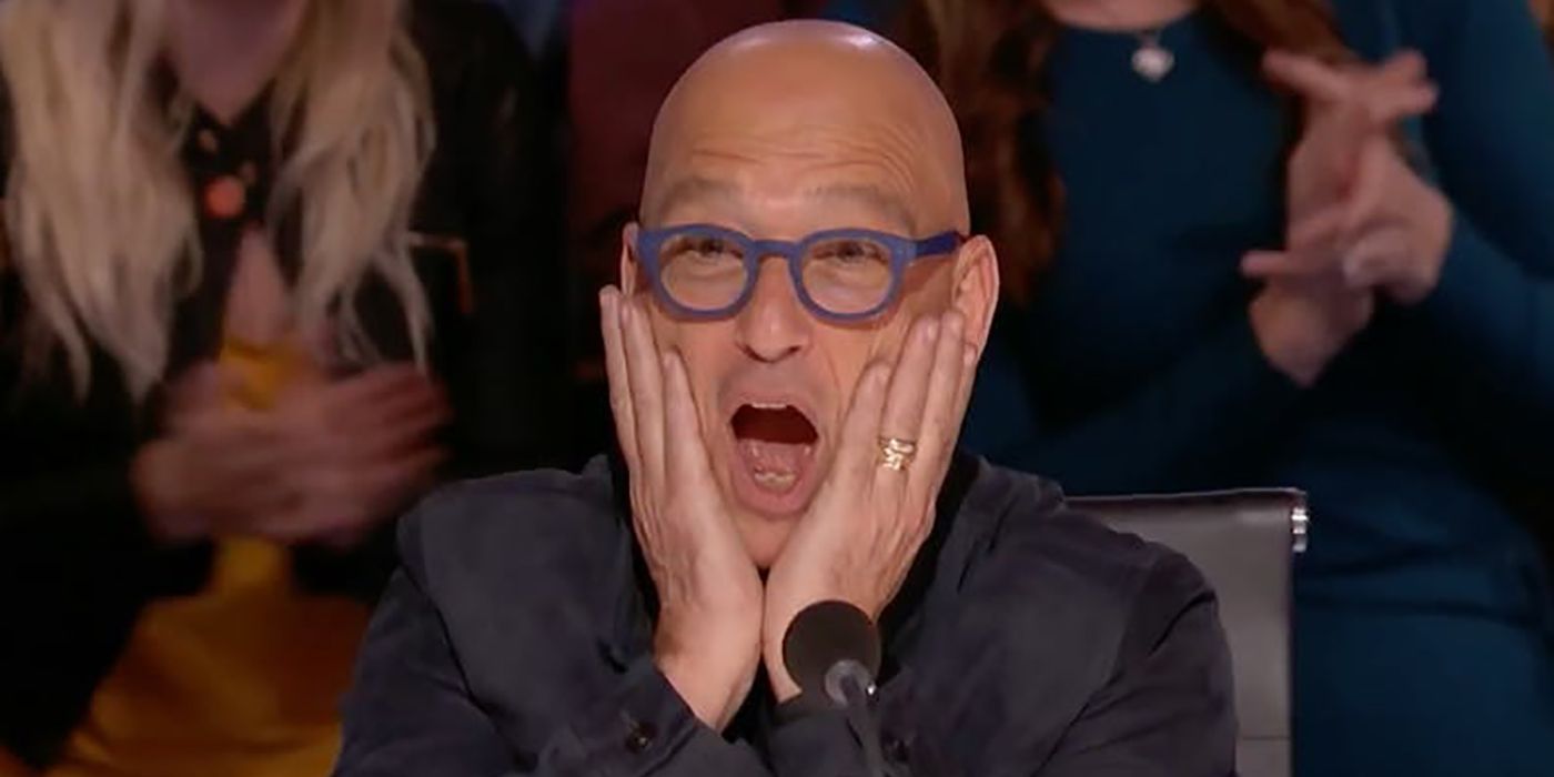 Howie Mandel with a shocked face, hands on his cheeks while judging America's Got Talent.