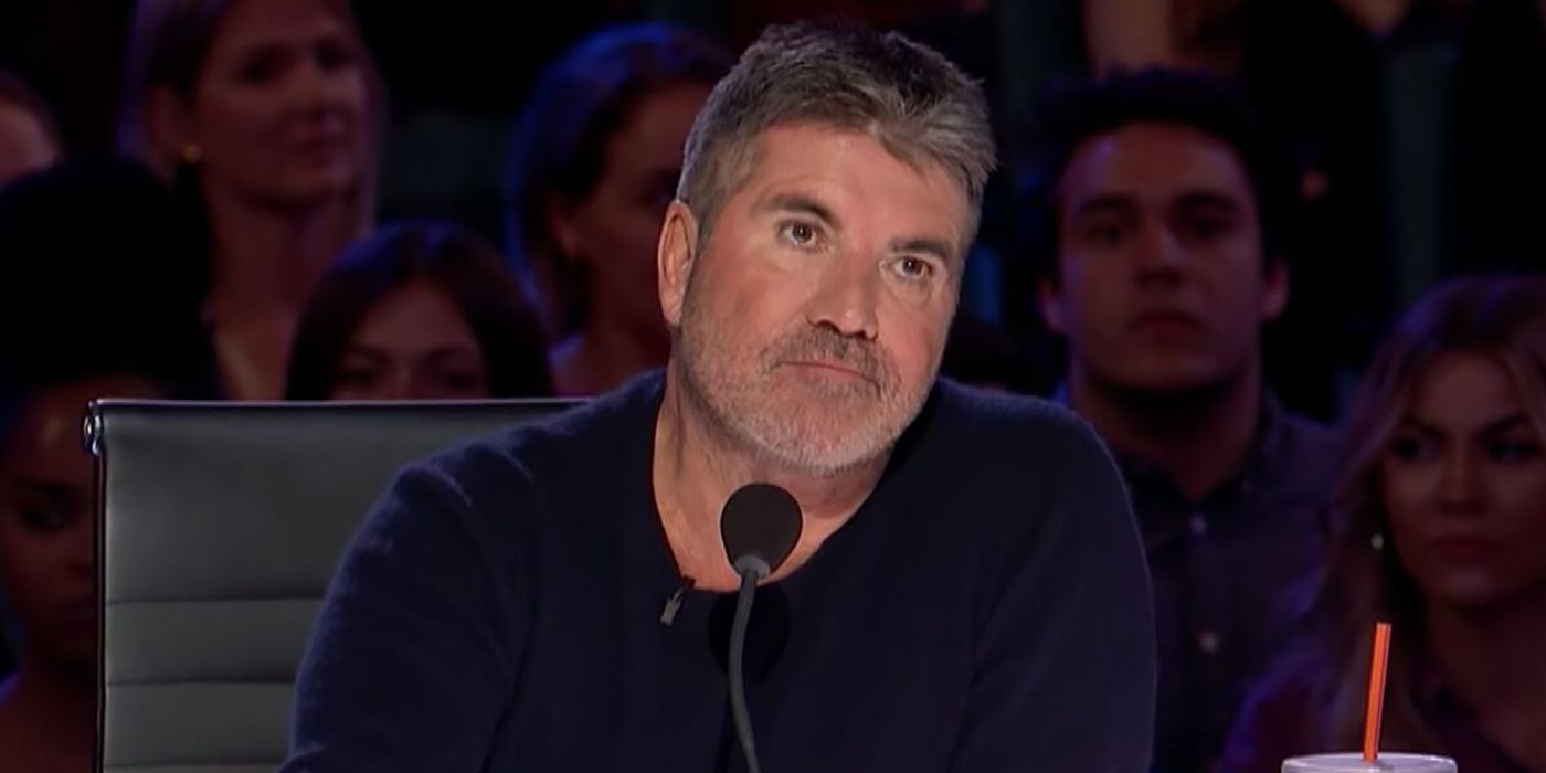 Simon Cowell watching an act on America's Got Talent, expressionless.