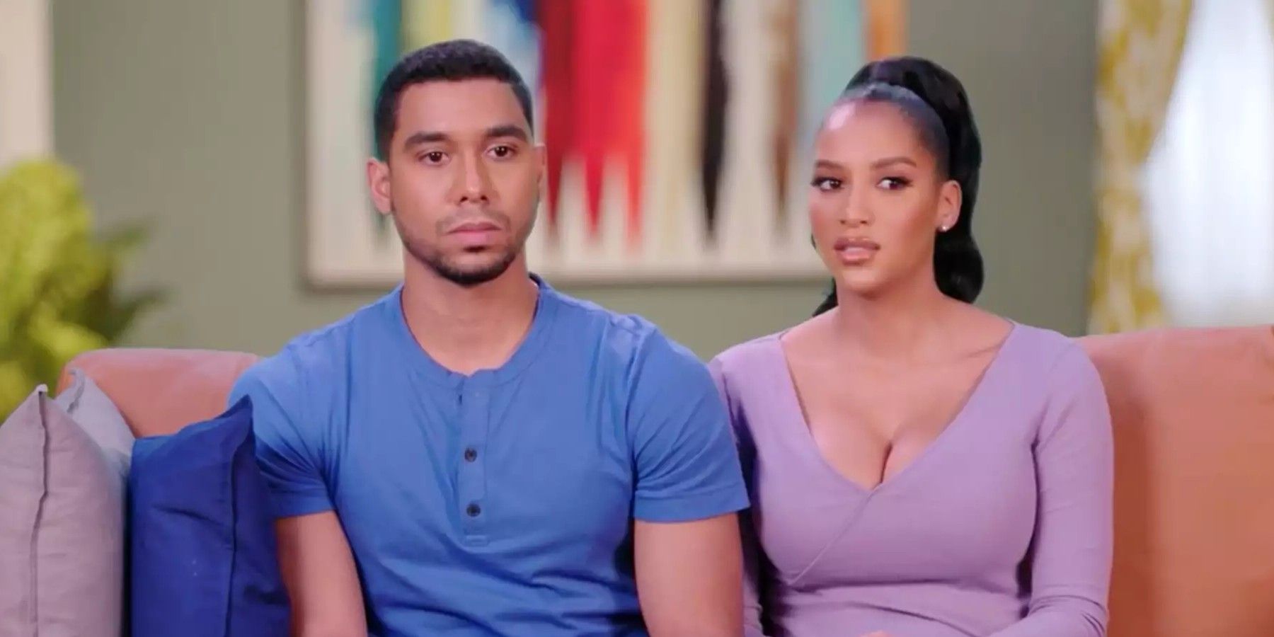 The Family Chantel Chantel Everett and Pedro Jimeno sitting on couch looking serious