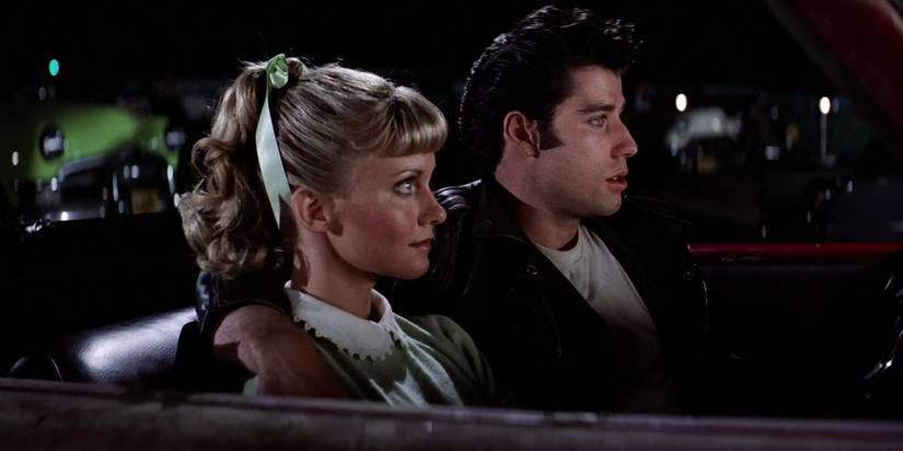 Sandy and Danny sitting in a car in Grease