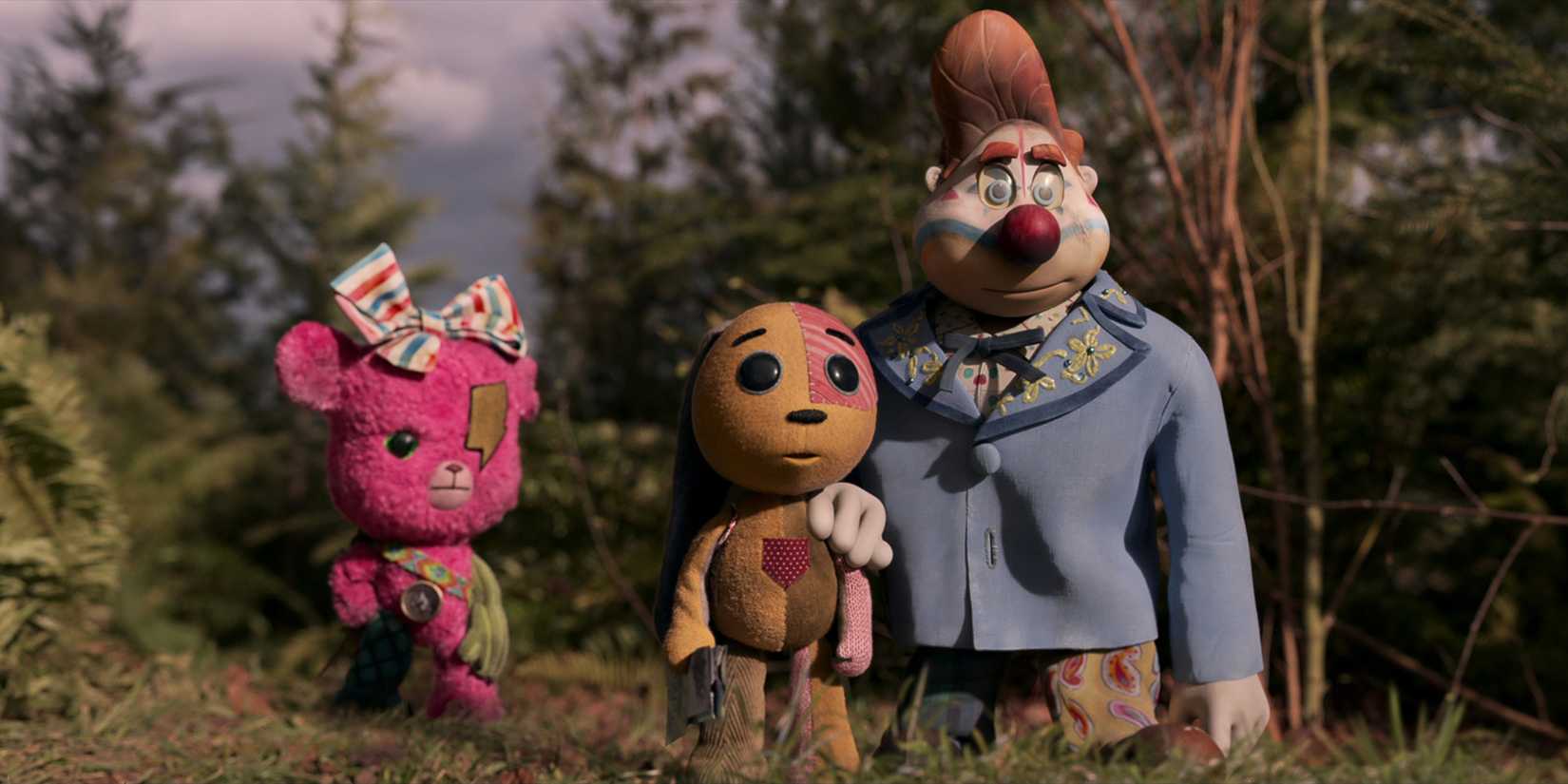 The toys of Lost Ollie standing in the grass