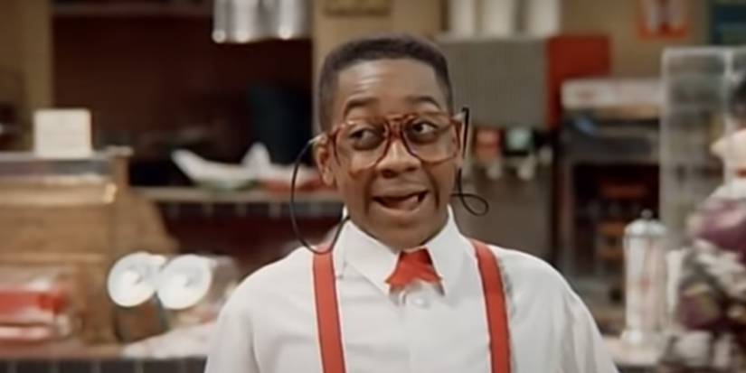 Steve Urkel from Family Matters wearing suspenders and glasses, mid-sentence.