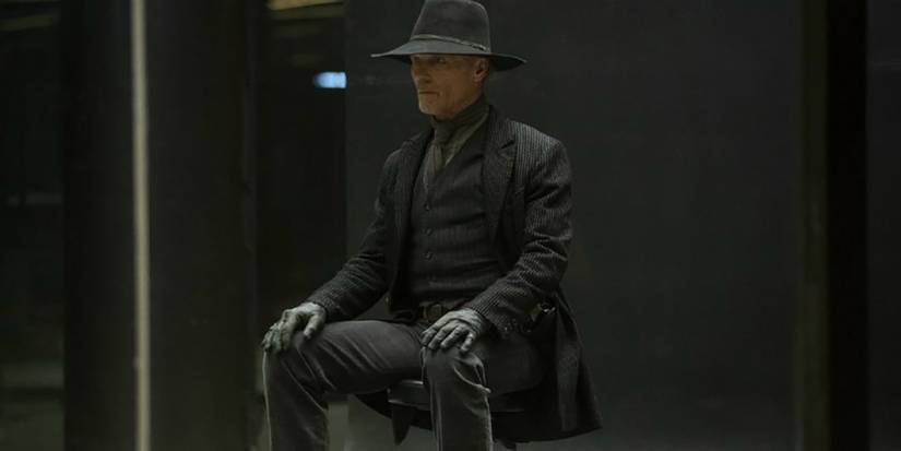 William, a.k.a. the Man in Black, sitting in a chair as his host version on Westworld.