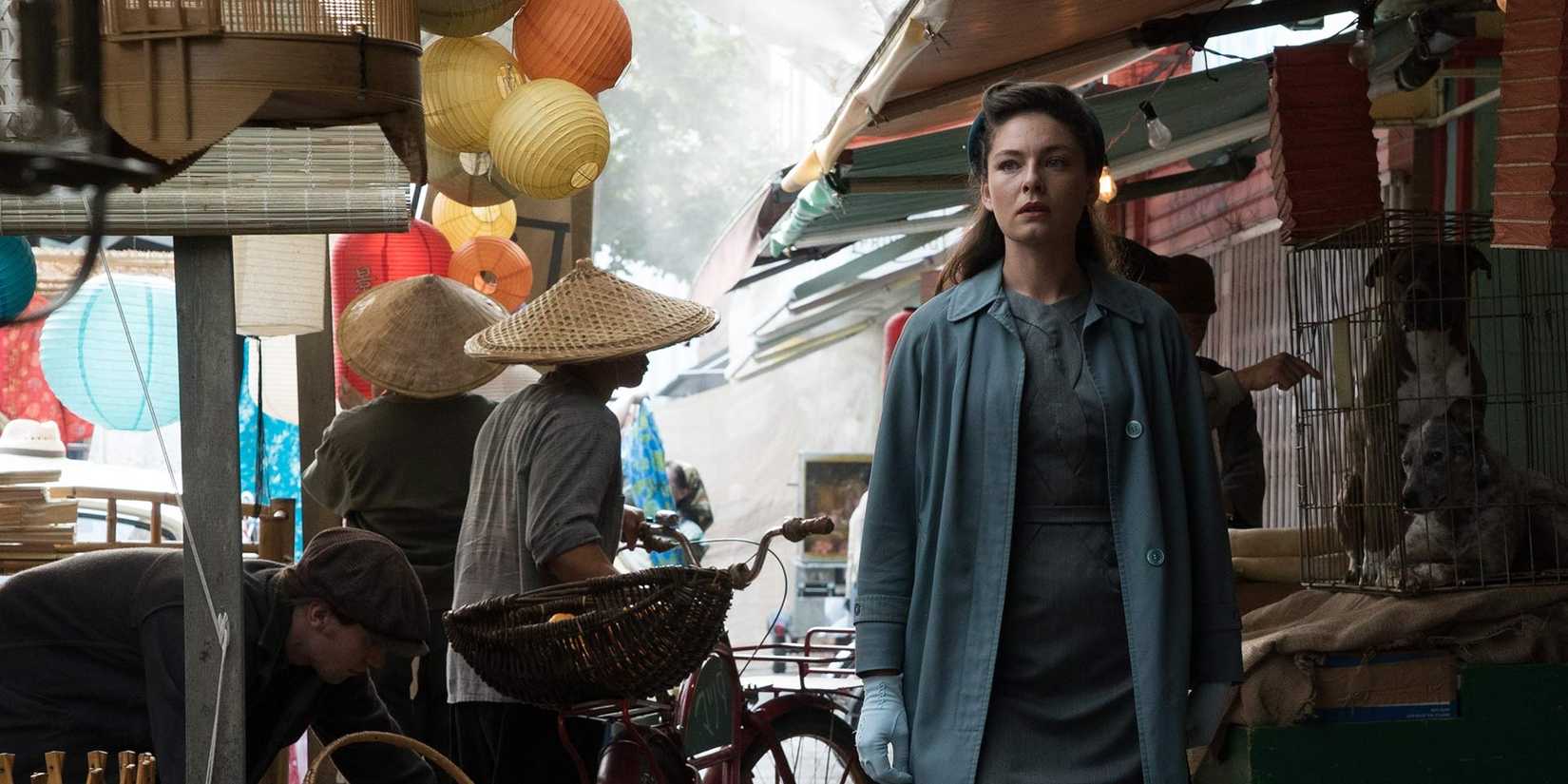 A woman walks in a lively street of the man of the high castle