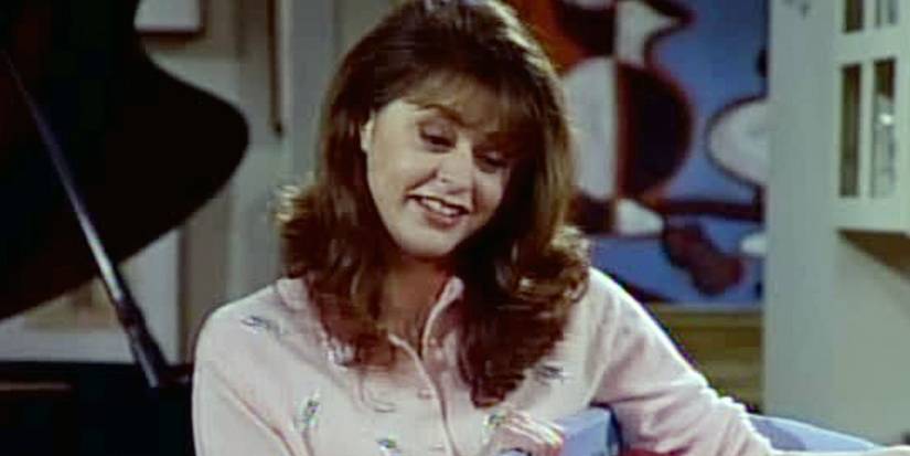 Daphne smiles in Frasier's apartment in Frasier