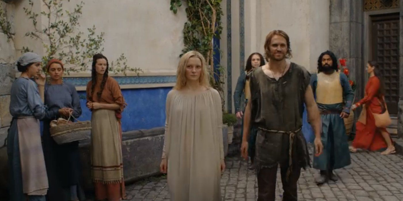 Galadriel and Halbrand walk through the streets of Numenor in The Lord of the Rings: The Rings of Power.