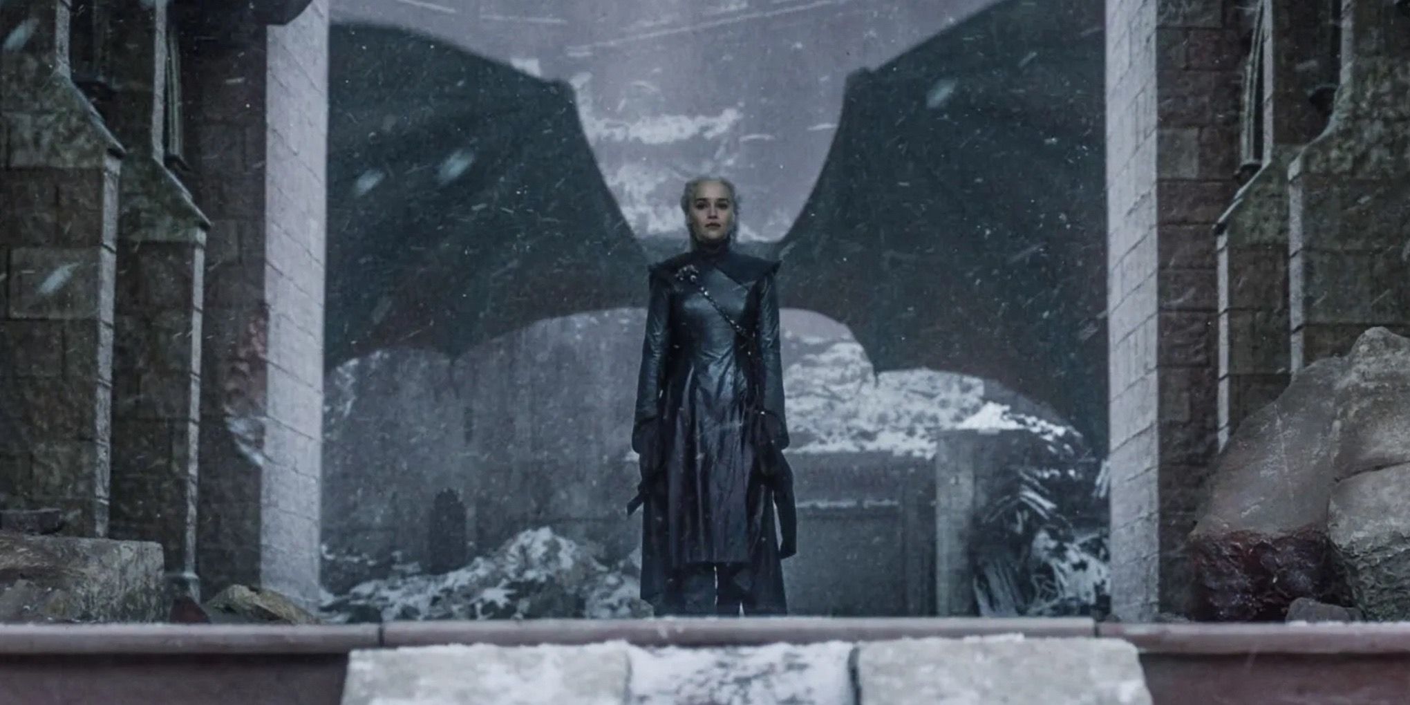 Emilia Clarke as Daenerys Targeryen and Drogon spreading his wings behind her in the Game of Thrones finale