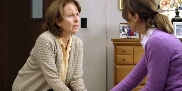 Ellis and Meredith Grey talking and holding hands on Grey's Anatomy