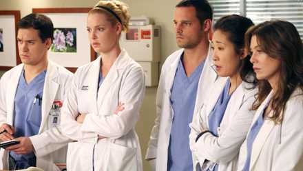 George, Izzie, Alex, Cristina and Meredith looking serious at the hospital on Grey's Anatomy