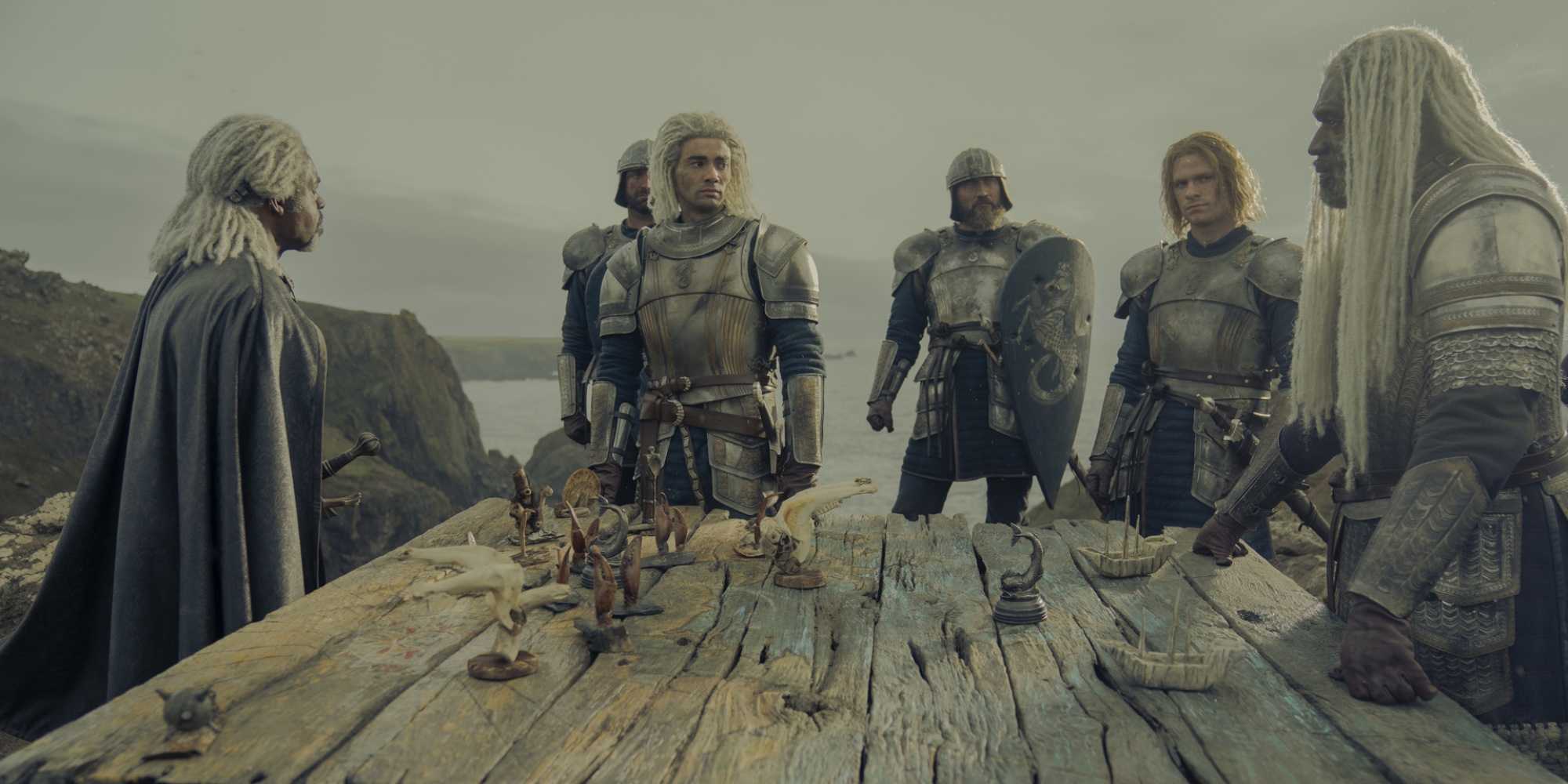 Vaemond, Laenor, and Corlys Velaryon around a table in in House of the Dragon