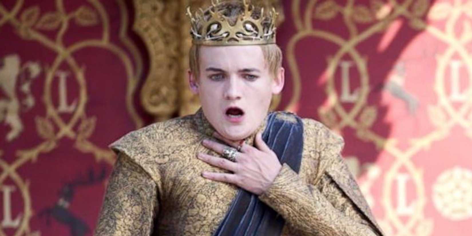 Jack Gleeson as Joffrey Baratheon holding hand to throat in Game of Thrones