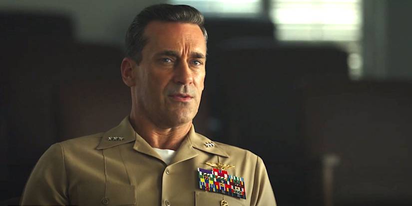 Jon Hamm as Cyclone in Top Gun Maverick in a military uniform having a serious conversation