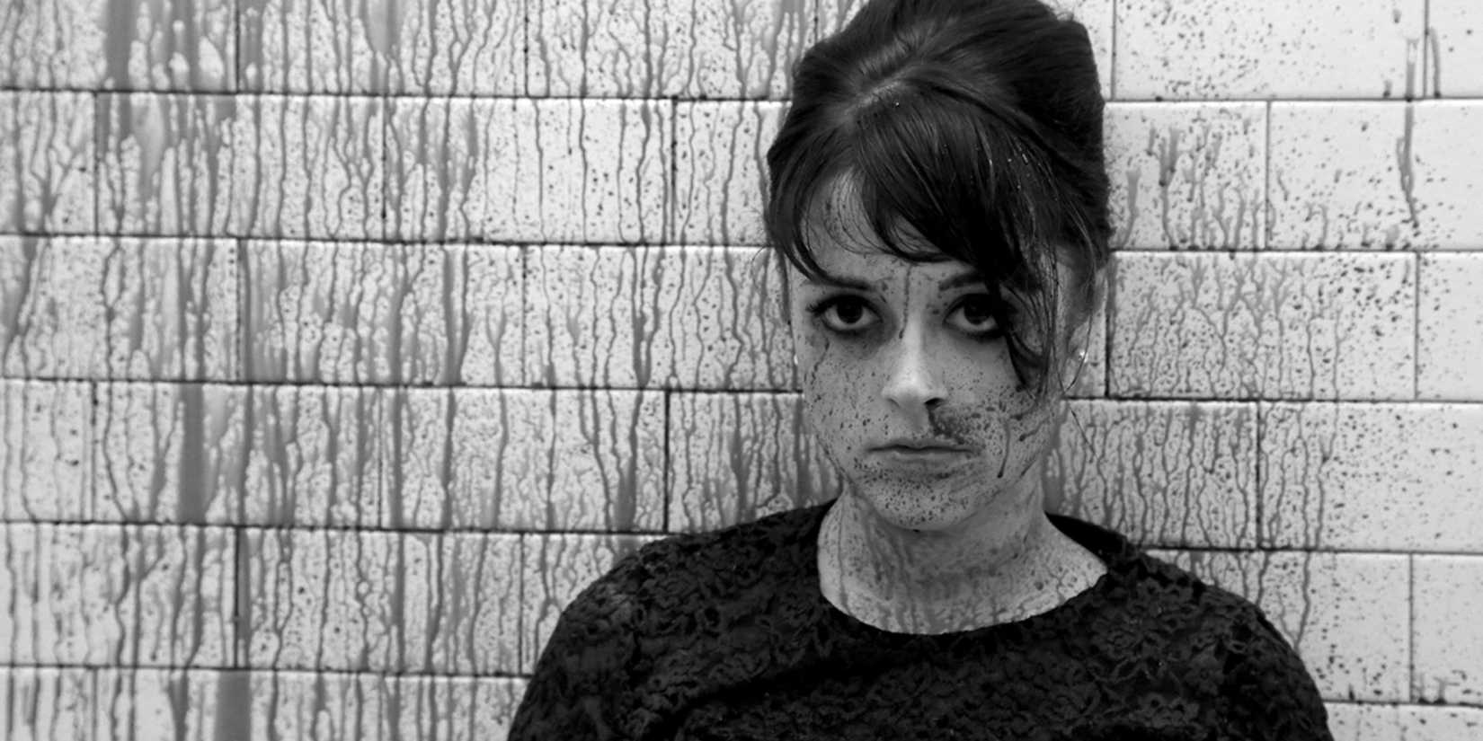 Lauren Ashley Carter stares into the camera splattered in blood in Darling 2015