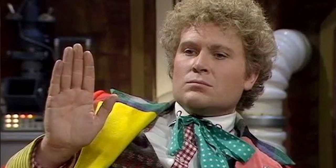 Sixth Doctor holding up his hand in Doctor Who 