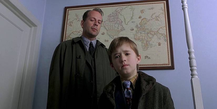 Cole standing in front of Malcolm while looking sad in The Sixth Sense