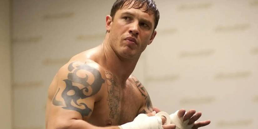 Tom Hardy as Tommy taping up his hands and looking furious in Warrior.