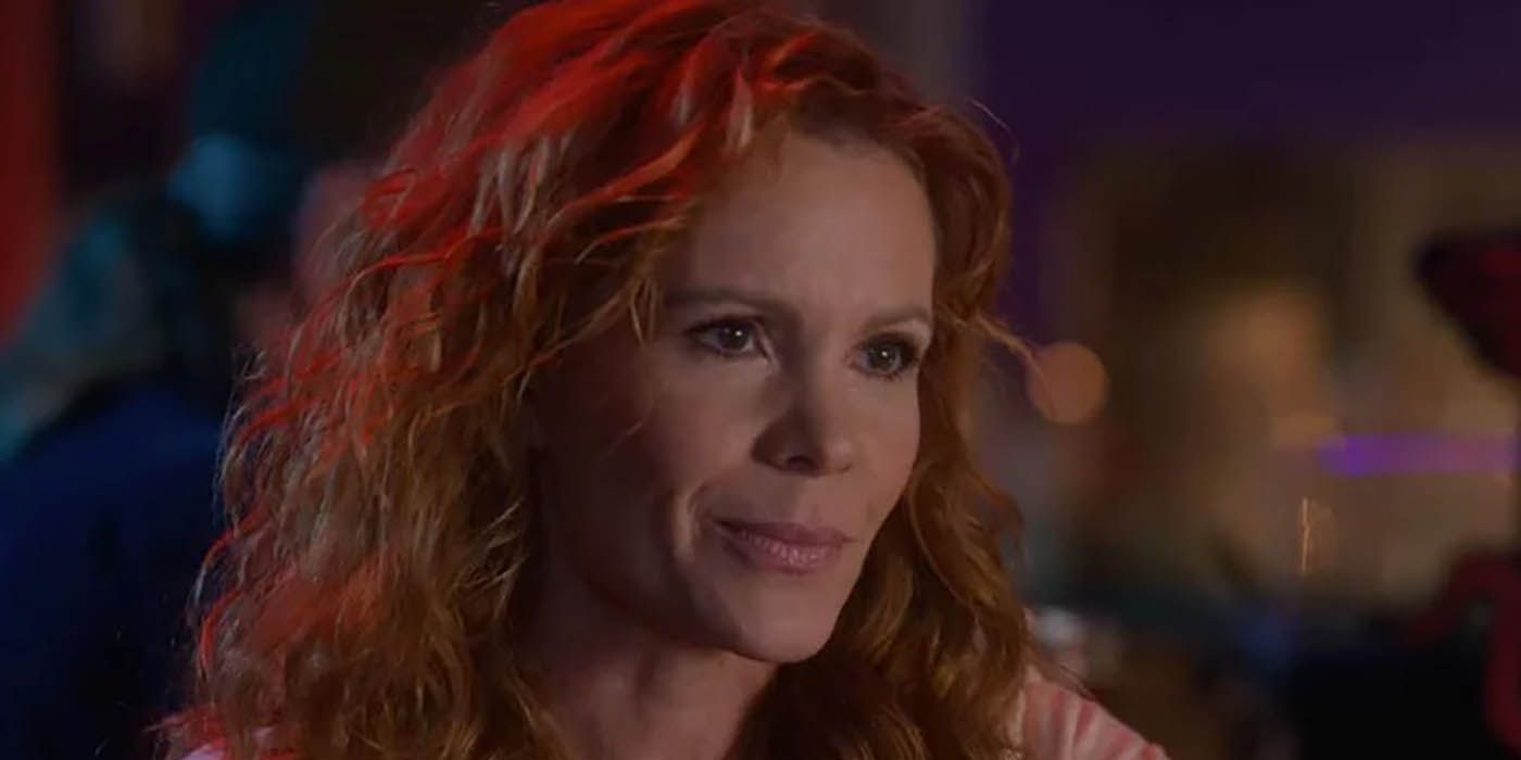 A close-up of Jessica from Cobra Kai, sitting at the bar with Amanda, who is out of view.