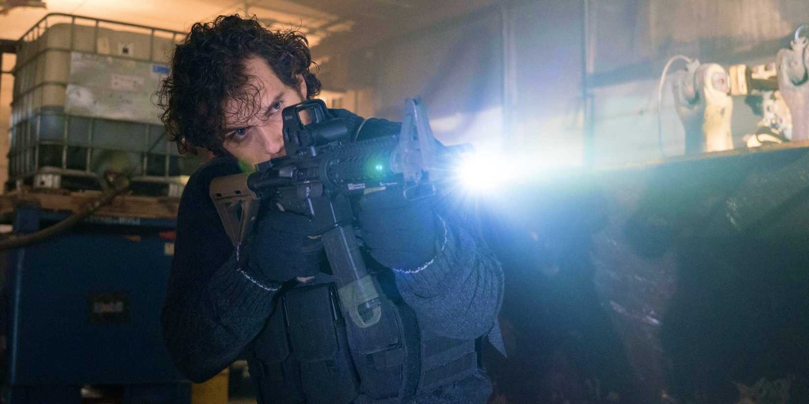 Walter Marshall pointing a gun at someone in Night Hunter.