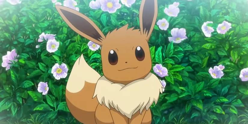 A female Eevee smiling in front of a bush of flowers in the Pokemon anime.