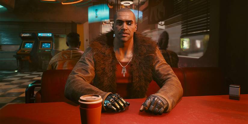 Ривер сидит напротив игрока в обеденном зале в Cyberpunk 2077