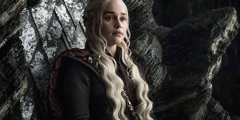 Emilia Clarke as Daenerys sitting on her throne on Dragonstone in Game of Thrones