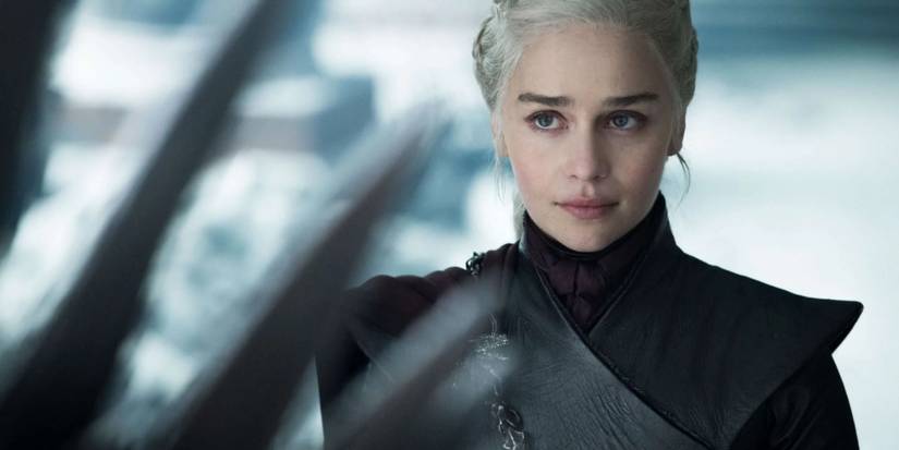 Emilia Clarke as Daenerys Targaryen looking at the Iron Throne in Game of Thrones season 8.