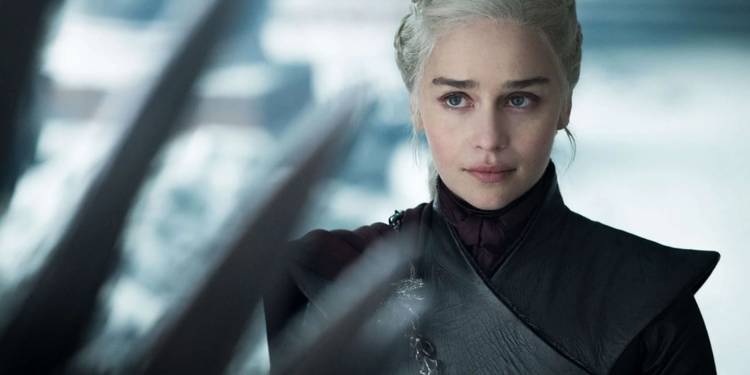 Emilia Clarke as Daenerys Targaryen looking at the Iron Throne in Game of Thrones season 8.