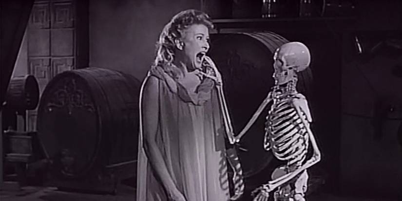 A skeleton startles a woman from House on Haunted Hill