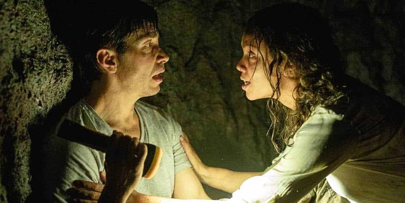 Justin Long as AJ with a flashlight and Georgina Campbell as Tess in Barbarian