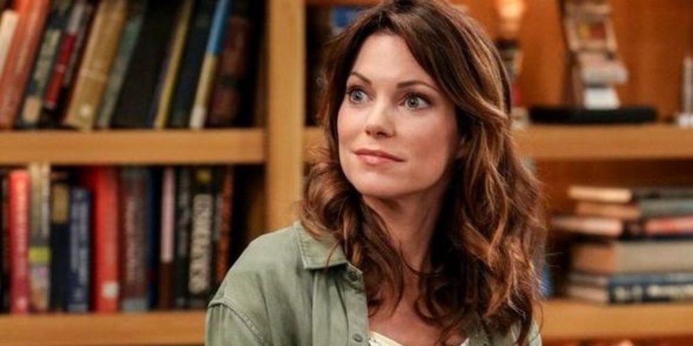 Missy Cooper smiles to her right in The Big Bang Theory 