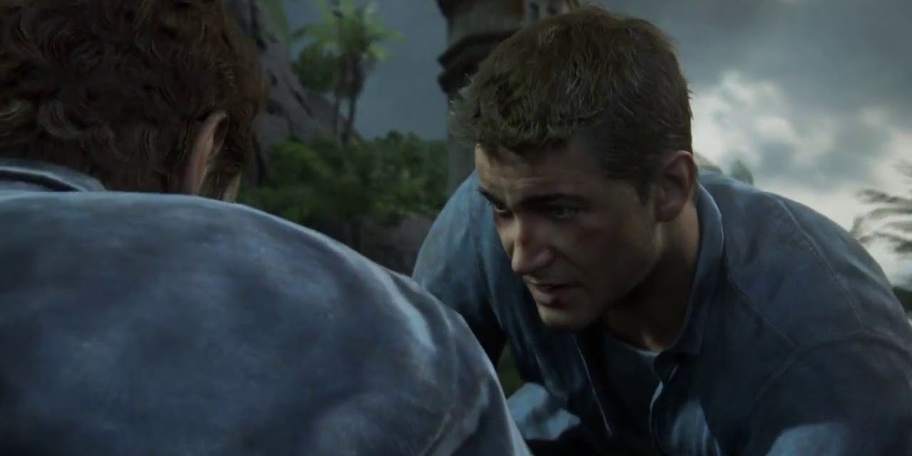 Nate tries to pull Sam up from a ledge in Uncharted 4 